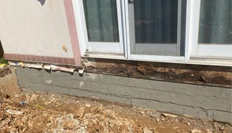 A house foundation in need of repair due to visible damage.